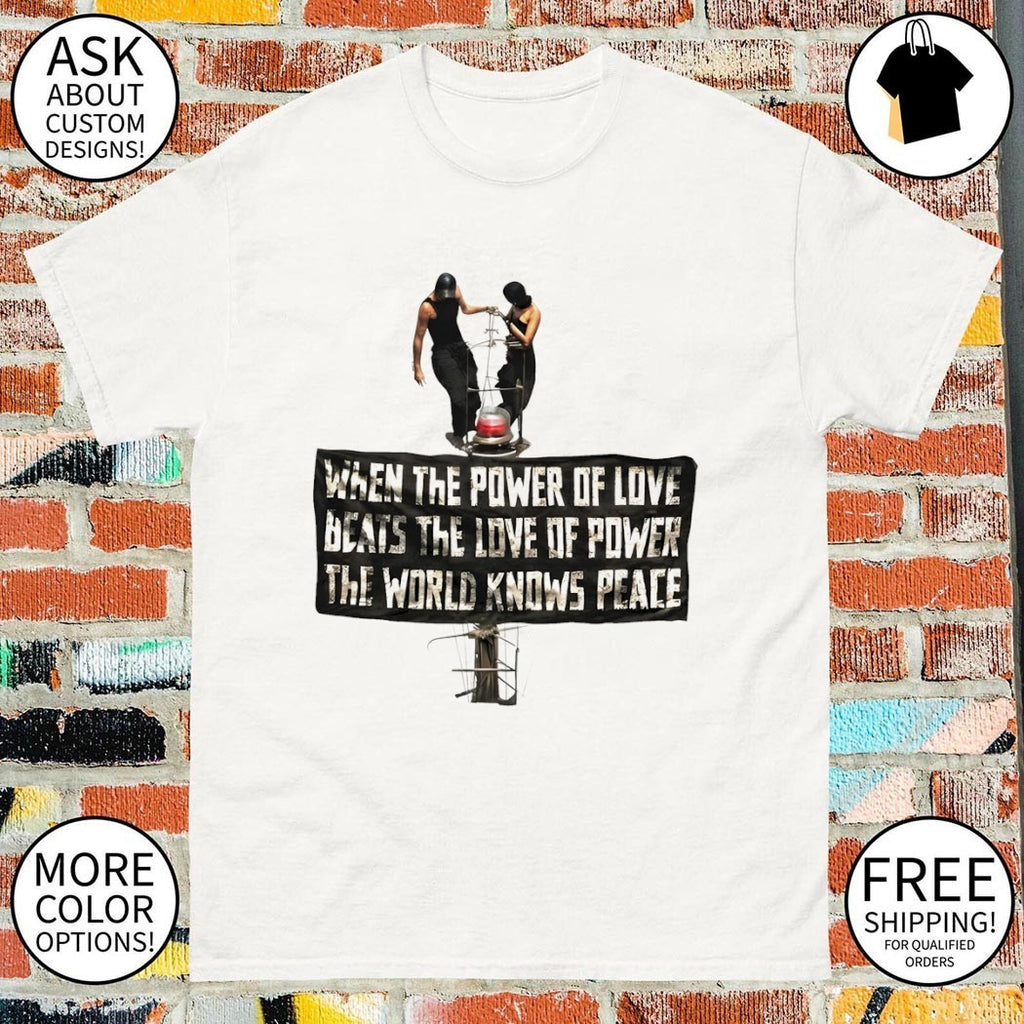 Angela Nikolau and Ivan Beerkus on tower When the Power of Love beats the Love of Power the World knows Peace shirt