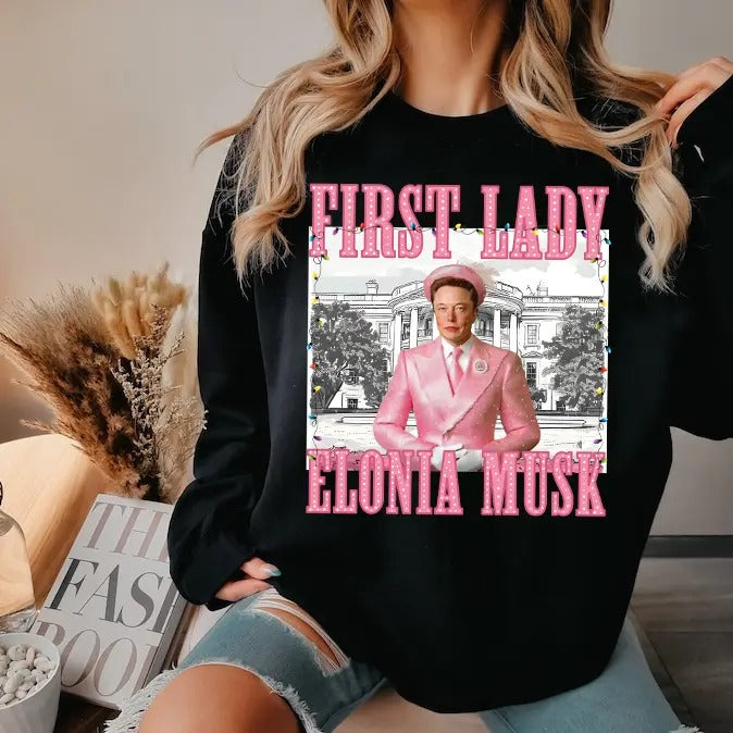 Elonia Mu.sk First Lady Christmas 2024 shirt - Unisex Heavy Cotton Tee Basic Hoodie, Sweatshirt | UrbanDripWear.com