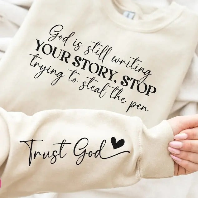 God Is Still Writing Your Story Sweatshirt - Front & Hand, Funny Christian Shirt, Faith Shirt Hoodie | UrbanDripWear.com