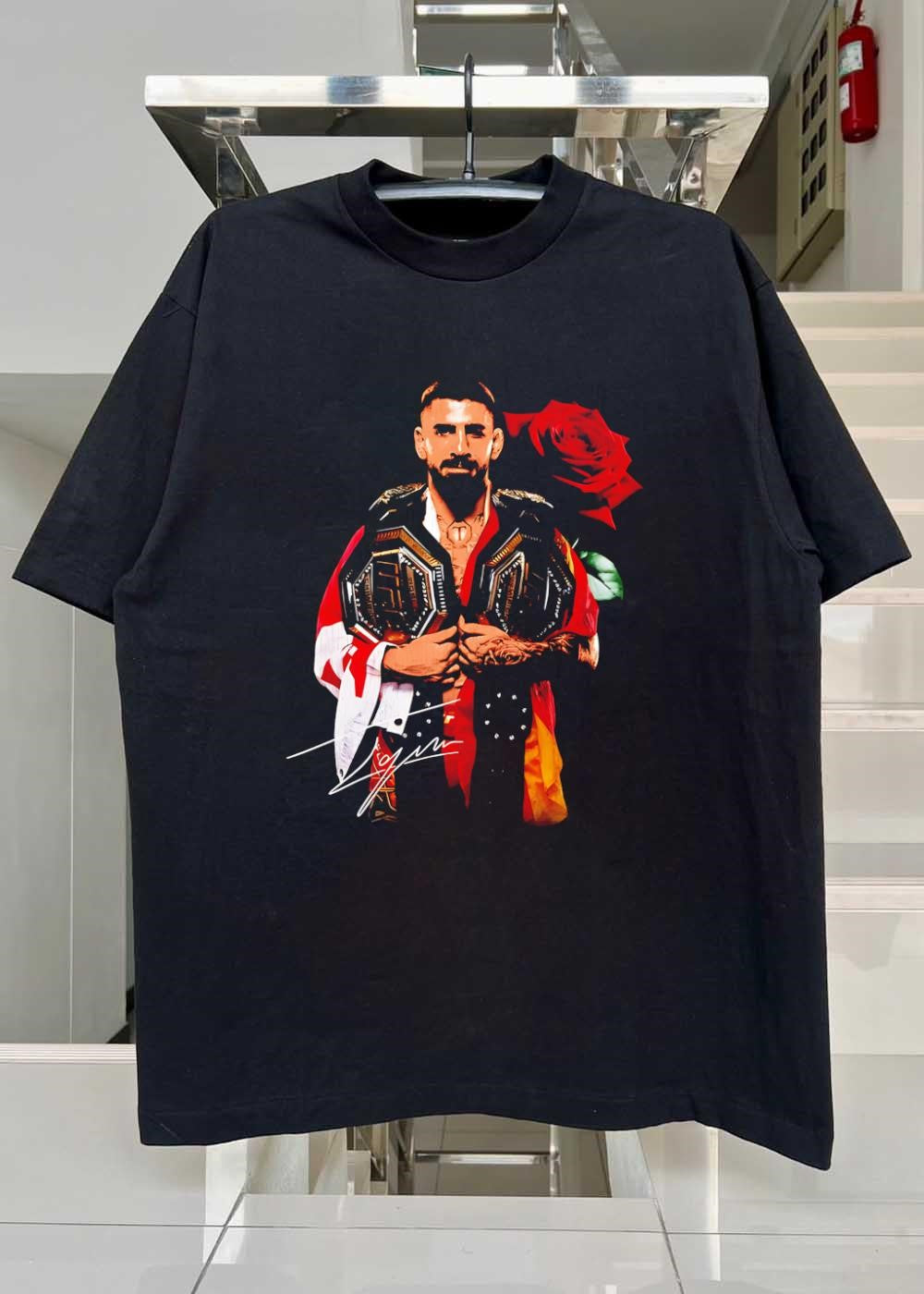 Ilia Topuria Holding UFC Championship Belts With Rose Shirt