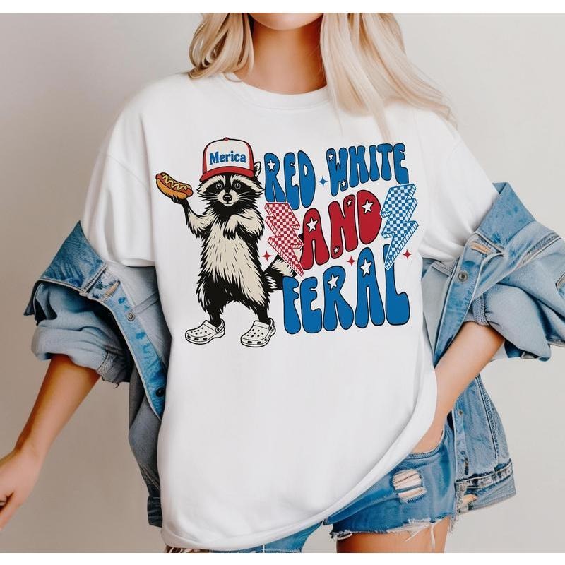 Trendy T - Shirt Featuring a Cool Raccoon: Stylish 'Merica' Look with Catchy 'Red White and Feral' Typography Hoodie,...