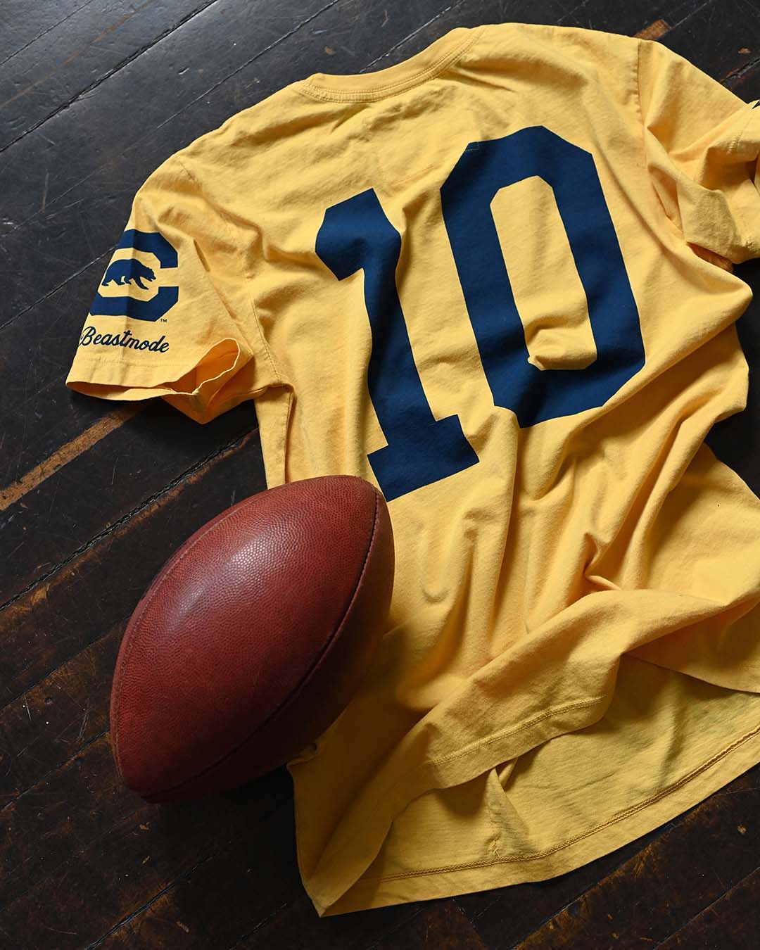 CAL - Marshawn Lynch #10 Gold Tee