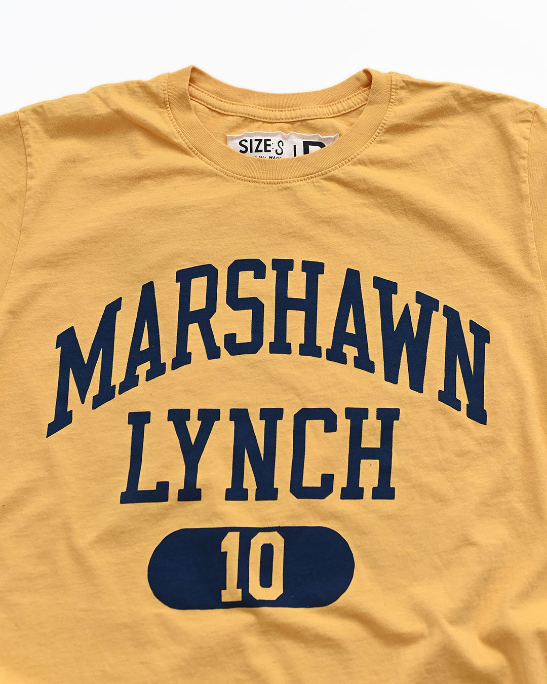 CAL - Marshawn Lynch #10 Gold Tee