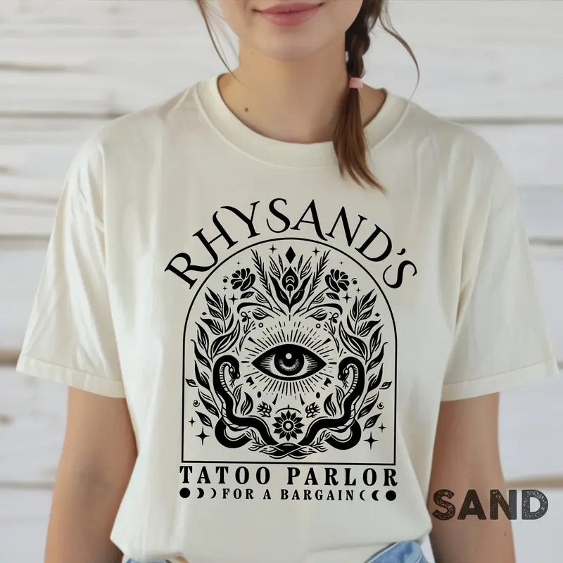 is a mAcotar Velaris Rhysand's Tattoo Parlor T-shirt featuring Feyre and Rhysandust-have for fans of the novel series....