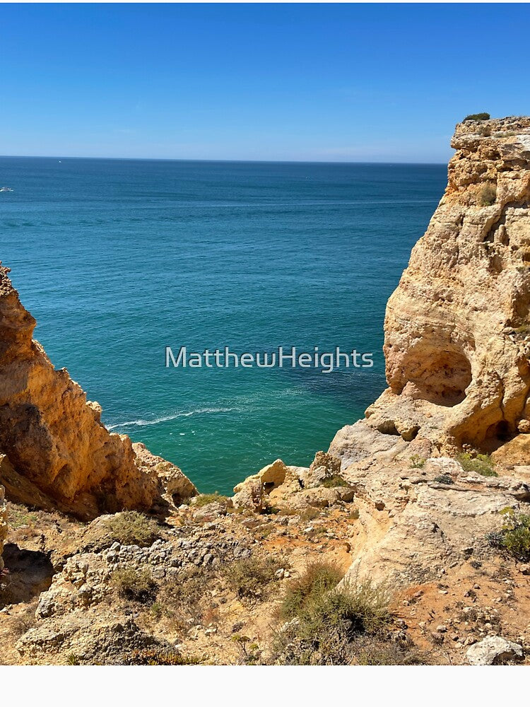 Golden Coastal Cliffs Over Turquoise Ocean by MatthewHeights