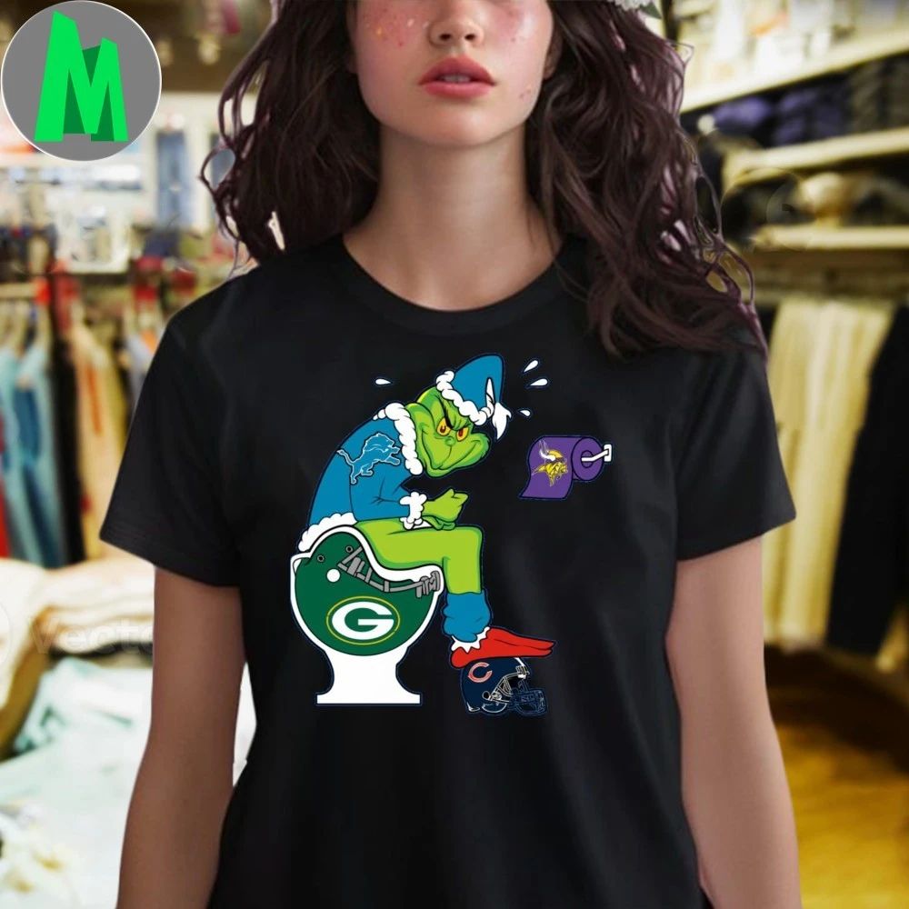 The Grinch wears a Detroit Lions jersey He sits on a Green Bay toilet And uses toilet paper with the Minnesota Vikings logo Shirt